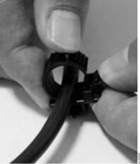 This figure shows how to unlock the cable retention bracket.